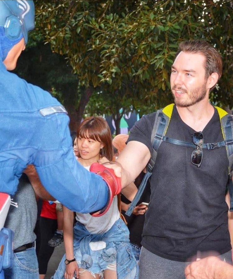 Maxwell shaking hands with Captain America at the park