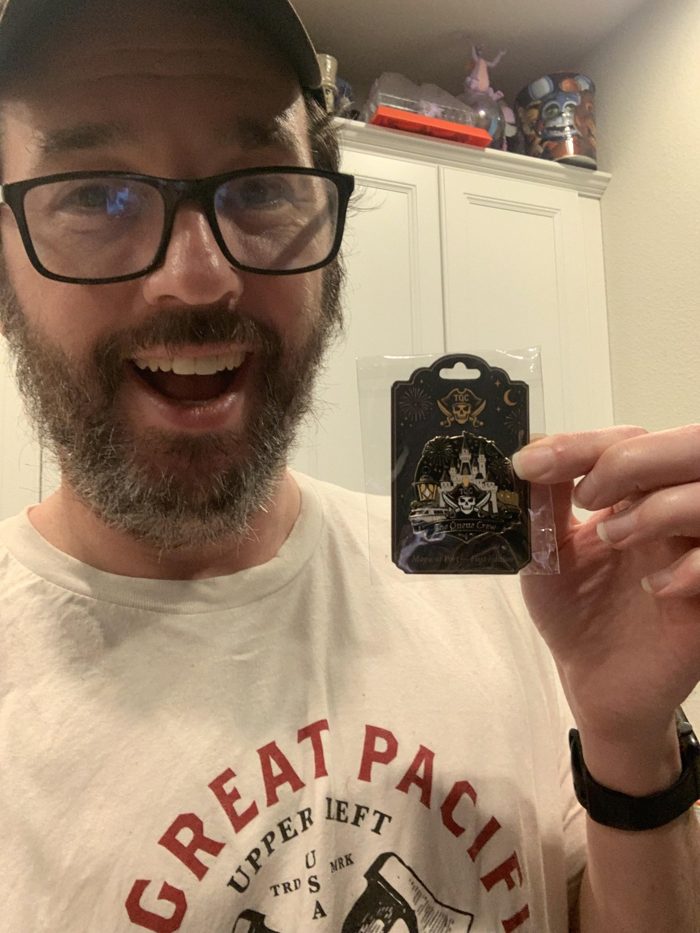 A Crewmate showing off a Queue Crew pin